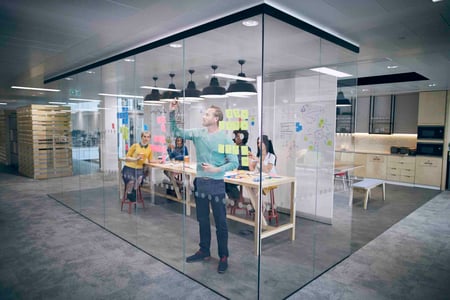 knowledge manager sketches a plan on a whiteboard